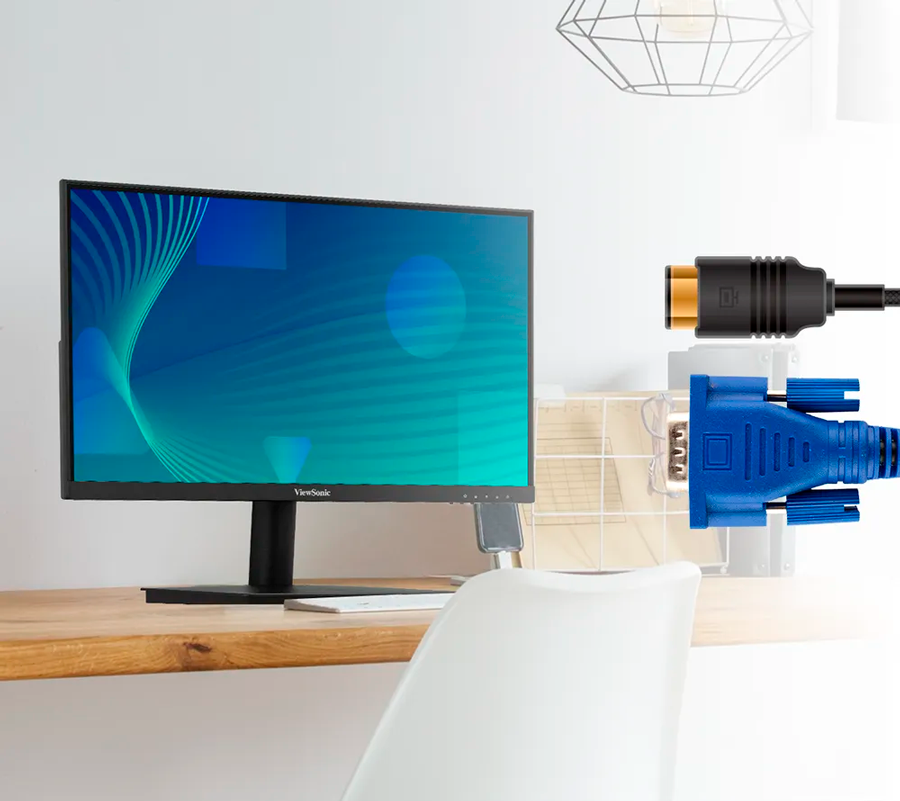Vista semifrontal de monitor Viewsonic VA220-H sobre escritorio acompa&ntilde;ado de cable HDMI y VGA destacando su versatilidiad de conexi&oacute;n