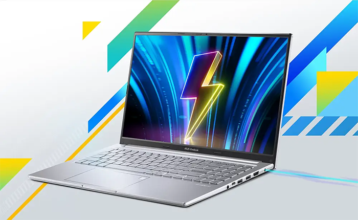Vista lateral izquierda del equipo, resaltando su perfil delgado y elegante. Se observa un puerto USB adicional y los indicadores LED de estado de bater&iacute;a y encendido.
