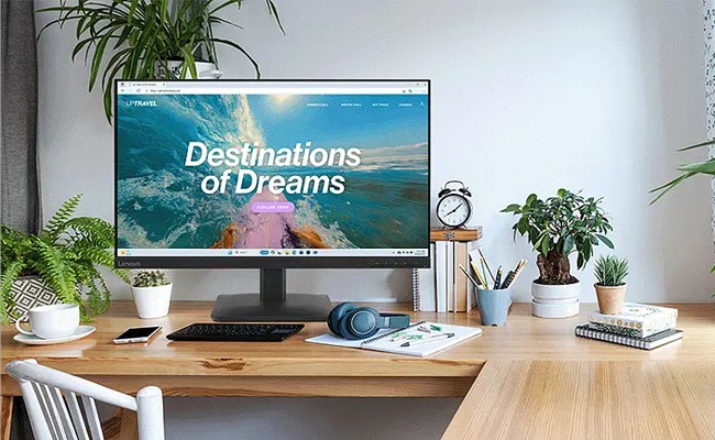 Vista frontal del monitor Lenovo L27-4e con pantalla de 27 pulgadas encendida. Presenta bordes muy finos en los laterales y la parte superior, con un marco inferior mas ancho donde se ubica el logotipo de Lenovo y una base rectangular moderna.